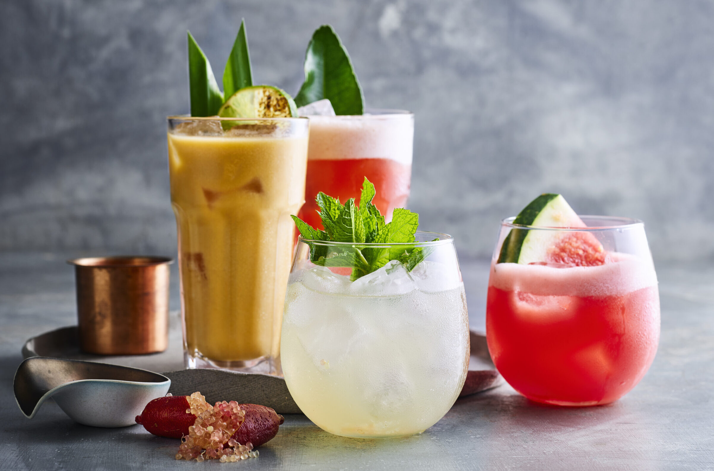 Assortment of colorful summer cocktails on a textured background. Assortment of colorful summer cocktails on a textured background.